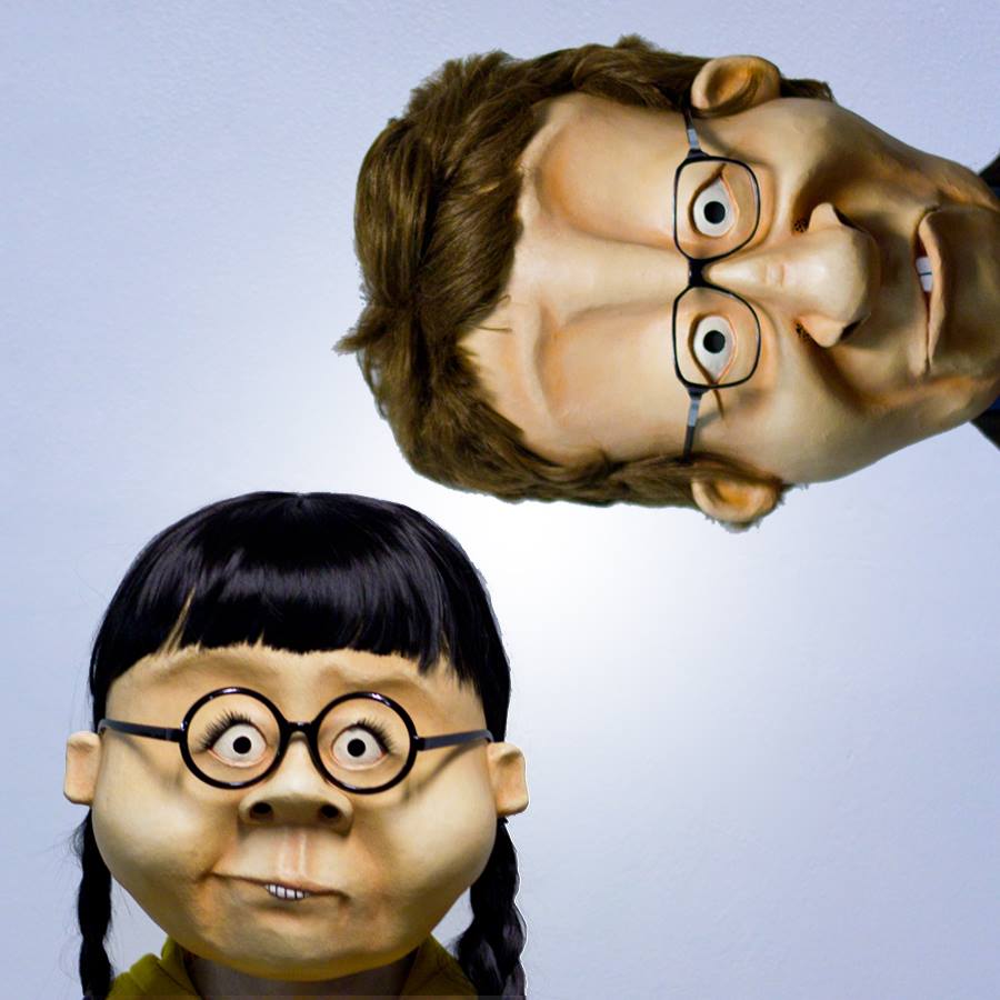 Two character from "The Middle of Everywhere". These masks completely surround the head and are fitted with accessories like wigs and glasses.