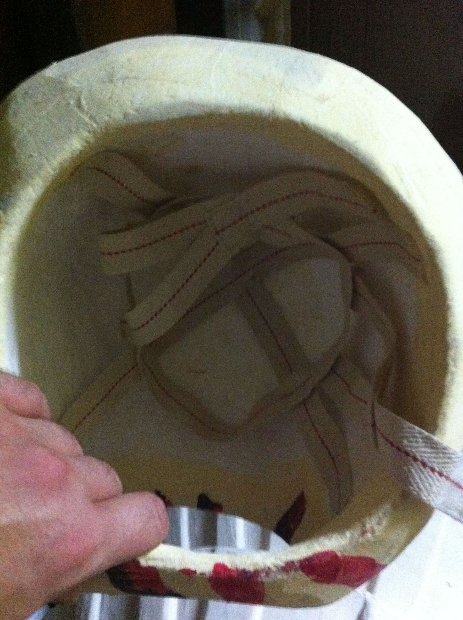 Looking at the bottom of a mask carved from thermocol by Sunil